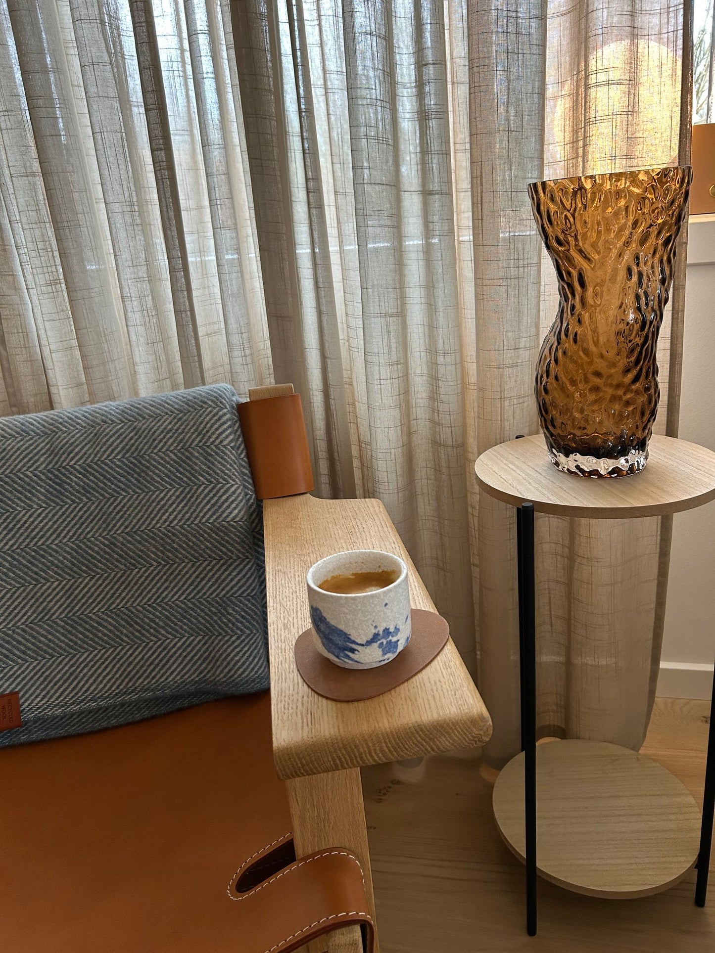 Kanazawa keramik kop stående på armlænet af en stol. Komorebi Studio.
